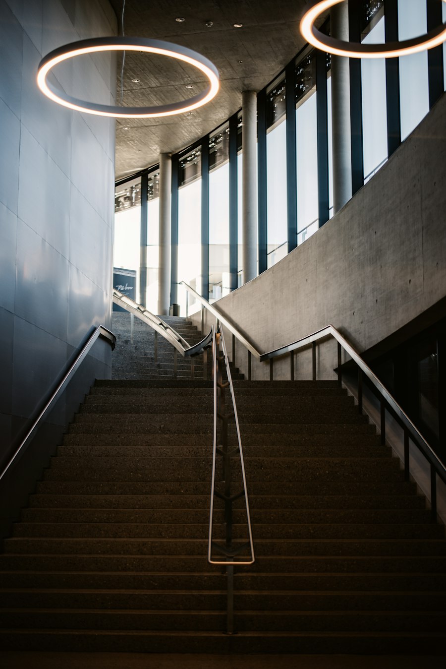 A staircase ascending through a light-filled modern building